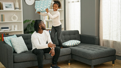 African american father and daughter sitting on sofa stressed for disturb at home