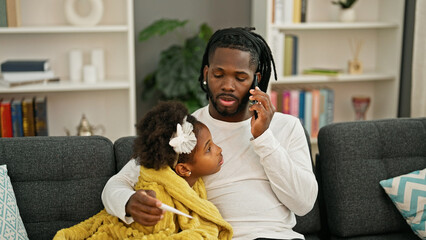 African american father and daughter having medical smartphone consultation being sick at home - obrazy, fototapety, plakaty
