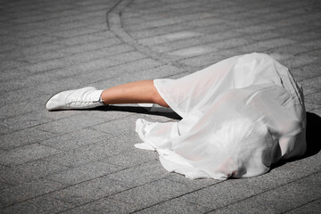 Female performer covered in white silk scarf waving gracefully, female outdoor dance performance on...
