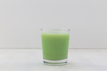 glass of Natural plant based Pistachio milk on the white background. Healthy diet. Natural product. Alternative milk. copy space