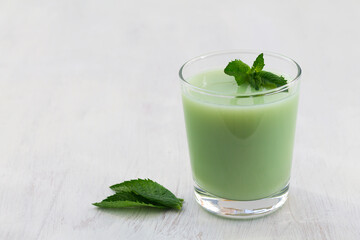 smoothie with mint. glass of Natural plant based Pistachio milk with green mint on the white background. Healthy diet. Natural product. Alternative milk. copy space