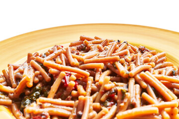 Close-up of traditional italian pasta with tomato sauce on a yellow plate, showcasing culinary delight.