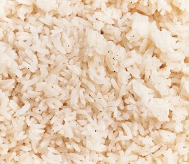 Close-up texture of cooked white rice on a full frame background, suitable for culinary themes and...