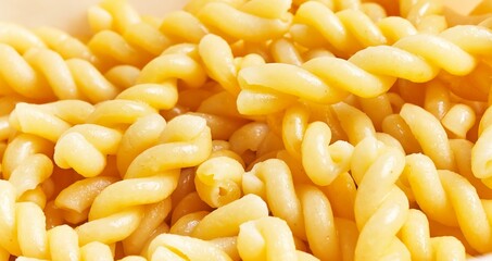 Close-up of cooked fusilli pasta ideal for cuisine, food, and italian culture themes.