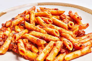  Delicious plate of italian macaroni with tomato sauce over isolated white background