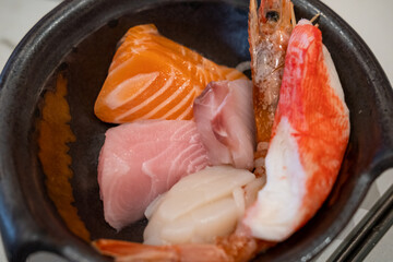 Variety of Sashimi served in a bowl including Scallop, Salmon, Tuna, Shrimp