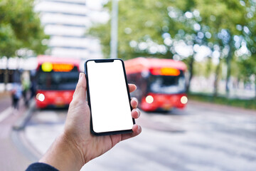 Man holding smartphone showing white blank screen at bus stop © Krakenimages.com