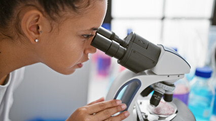 In the heart of a lab, a young, beautiful hispanic woman scientist, with curly hair, passionately...