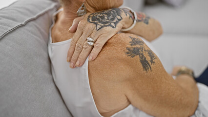 Backache blues, elderly woman suffering from severe back pain, hands clutching her ache while...