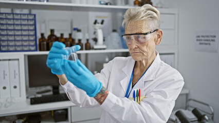 Naklejka premium In the heart of science, a senior grey-haired woman scientist measuring liquid with concentration in a laboratory test tube