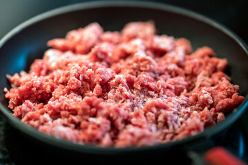 Chopped up mince meat in frying pan.