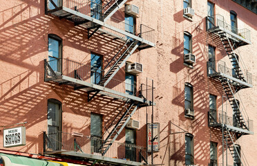  Exterior of a building with old fire escape in  New York City