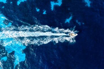 Vacation and leisure. Aerial view on fast boat on blue Mediterranean sea at sunny day. Fast ship on...