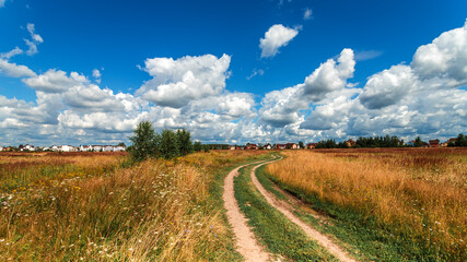 Naklejka premium Summer village landscape with beautiful clouds and village road.