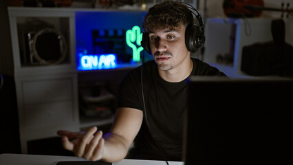 Handsome young hispanic man, a streamer in his gaming room, engaging in a digital conversation...