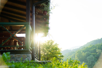Porch of a wooden house in the forest on the river bank - obrazy, fototapety, plakaty