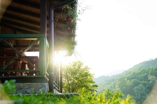 Porch of a wooden house in the forest on the river bank