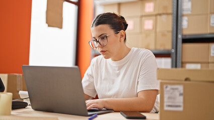 Young beautiful hispanic woman ecommerce business worker typing on computer at the office