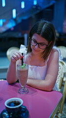 Gorgeous hispanic woman, delighting in a smooth, creamy milkshake at kabukicho, tokyo's business hub