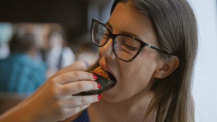 Gorgeous hispanic woman savoring exquisite uni sushi, a culinary feast of japanese seafood delicacy...
