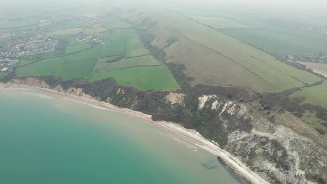 aerial flying across the ballard cliff of Swanage, Travel destination of Dorset, England, overcast day