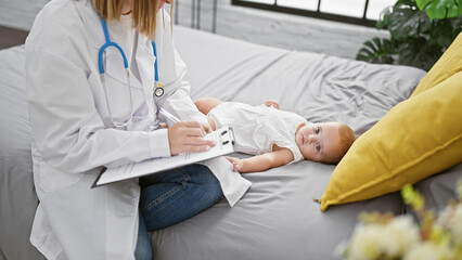 Pediatrician in uniform, patiently sitting on a bedroom bed, seriously examining baby, meticulously...