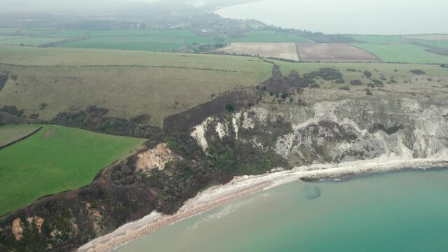 aerial flying across the ballard cliff of Swanage, Travel destination of Dorset, England, overcast day