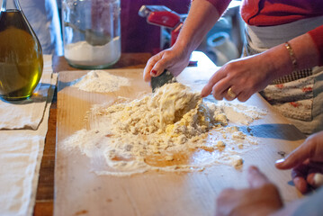Female hands mixing flour for homemade pasta dough
