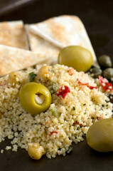 Macro Side View of Pita, Couscous, Olives, Capers and Chickpeas