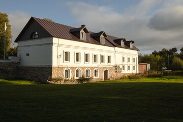 The carriage house at the historical estate. A historic building in the rays of the autumn sun.