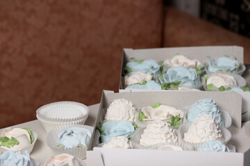 Marshmallows in open gift boxes. Zephyr fir cones and Zephyr flowers. Homemade Zephyr.