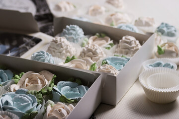 Marshmallows in open gift boxes. Zephyr fir cones and Zephyr flowers. Homemade Zephyr.