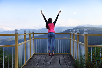 Young woman standing on viewing platform
