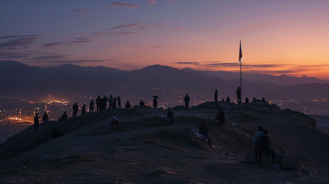 At the break of dawn, people gather on a hilltop to witness the raising of the Nowruz flag, a symbolic act heralding the arrival of the New Year. The early morning light and the fe