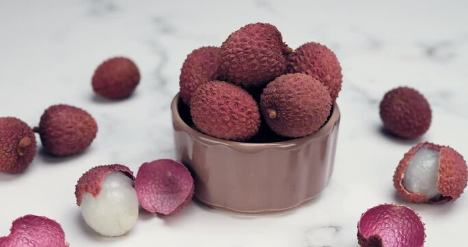 Lychee tropical fruit in bowl. Litchi contains essential nutrients, vitamins, antioxidants and minerals. Litchi protects against oxidative stress, heart diseases, diabetes, cancers. Healthy food. 4k