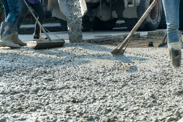 Cement mortar work. Construction trowel level tools. Asphalt road.
