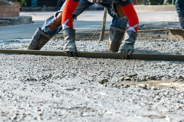 Cement mortar work. Construction trowel level tools. Asphalt road.

