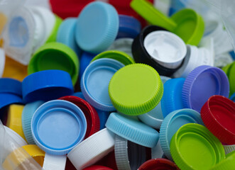 Colourful of plastic caps made from polypropylene or PP grade that can recycle and environmentally friendly. spot focus.