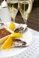 Fresh oysters shell with lemon and glasses of champagne. Top of view