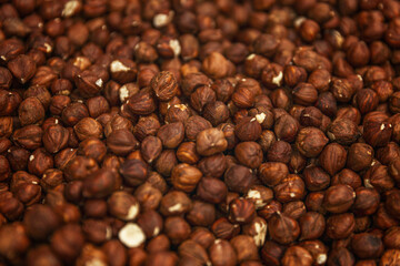 Lots of shelled hazelnuts on the counter. Veganism and healthy eating. Background. Space for text.