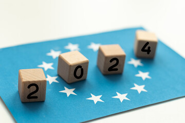 European Union vote, 2024on wooden blocks against the background of the EU flag, the concept of voting and taking part in the European elections