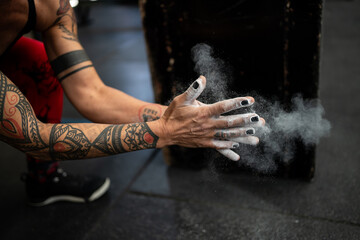 Hands with magnesium clasping ready to weightlifting in a gym