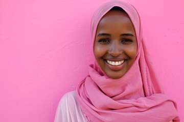 A smiling woman wearing a pink headscarf Generative AI