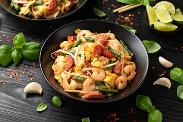 Char kway teow with rice noodles, prawn, sausages, egg and vegetables