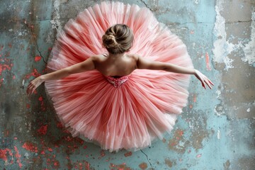 Top view of seated ballerina with pink tutu