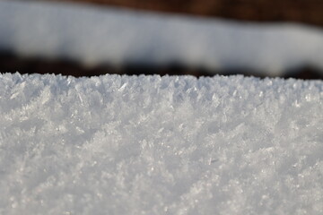 Close-up of snow crystals on a sunny day. Winter background.