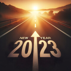 2023 New Year Background Design. Text 2023 written on the road in the middle of asphalt road at sunrise.Empty asphalt road and New year 2023 concept. Driving on an empty road to Goals 2023 with sunset