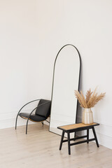 Stylish black mirror near white wall