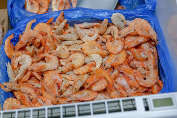 Frozen shrimp in the refrigerator in the supermarket. Healthy food and diet. Close-up.