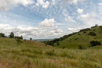 Fototapeta na wymiar The Lagoon Valley Park in Vacaville, California, USA, from up the mountain on a partly cloudy day and blue sky copy-space
